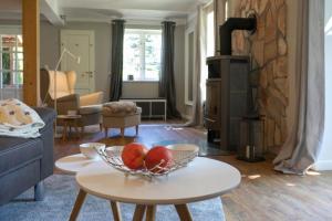 a living room with a bowl of fruit on a table at Pferdeblick in Gelting