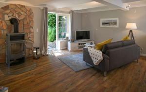a living room with a couch and a fireplace at Pferdeblick in Gelting