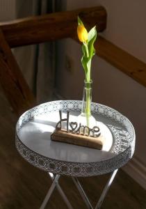a yellow flower in a vase on a table at Pferdeblick in Gelting +9 photos