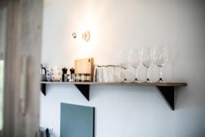 a shelf on the wall with wine glasses on it at GERN Magnolie in Unterwössen