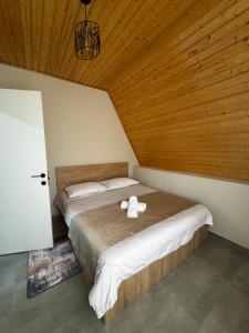 a bedroom with two beds and a wooden ceiling at Cottage Velli in Saketsia