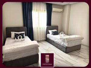 Postel nebo postele na pokoji v ubytování Zayed Hotel