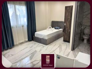 Postel nebo postele na pokoji v ubytování Zayed Hotel