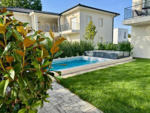 a swimming pool in the backyard of a house at Nexus apartman in Siófok