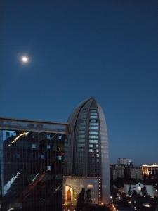 a large building with a moon in the sky at Modern 1 bedroom in the middle of Kilimani in Nairobi