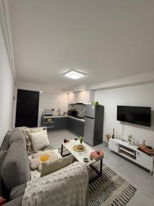 a living room with a couch and a tv at Modern 1 bedroom in the middle of Kilimani in Nairobi