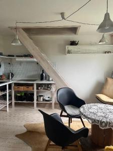 a living room with a table and two chairs at Apartmán pod lesem in Hazlov +24 photos