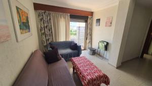 a living room with a couch and a tv at Apartment in Rota Cadiz, terrace AC wifi in Rota