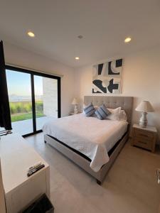 a bedroom with a large bed and a large window at Family-Friendly Oceanview Retreat Resort Access in Cabo San Lucas +14 photos