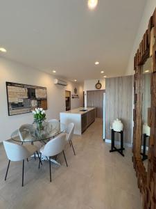 a dining room with a glass table and white chairs at Family-Friendly Oceanview Retreat Resort Access in Cabo San Lucas