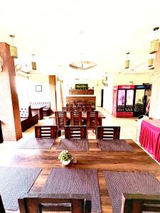 a restaurant with wooden tables and chairs in a room at Kasauli View Resort # Parking # lift # Garden # Restaurant # Open Terrace # On Road Location in Kasauli