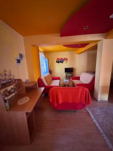 a living room with a couch and a table at Vila Khalo in Mangalia