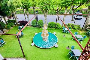 an aerial view of a fountain in a park at Hotel Punta me Torreblanca Palace in Guadarrama