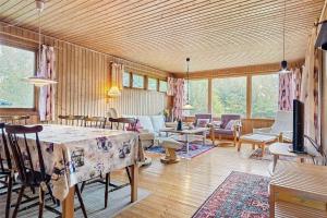 a living room with a table and chairs and a television at 3037-Stege-Forgarden-24 in Stege