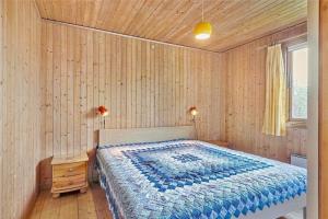 a bedroom with a bed and a wooden wall at 3037-Stege-Forgarden-24 in Stege