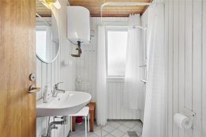 a white bathroom with a sink and a shower at 3037-Stege-Forgarden-24 in Stege +16 photos