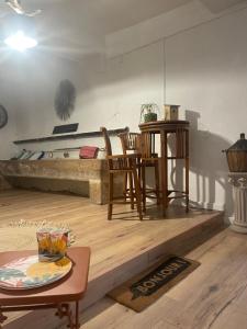 a living room with a bed and a table and chairs at Ô banc de la vigne in Fabrezan