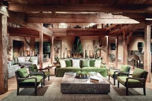 a living room with green couches and a table at Mount Med Resort in Oberau +49 photos