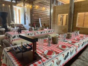 a table with a red and white table cloth at La Chotte du Musher in Champéry