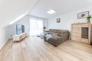 a living room with a couch and a tv at New & Modern Apartment near Düsseldorf in Willich