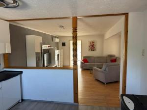 a kitchen and a living room with a couch at Haveleck in Ketzin