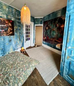 a room with a bed and a painting on the wall at Chambre chez l habitant in Saint-Hilaire-du-Harcouët