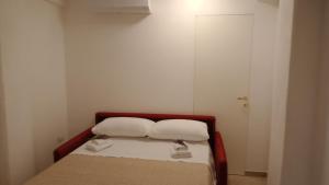a small bedroom with a bed with two pillows on it at Casa Pie' di Monte Refuge in Bisegna