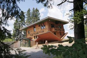 a large wooden building in the middle of trees at Sternenacht in Sankt Englmar