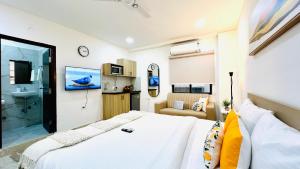 a bedroom with a large bed and a bathroom at Olive Serviced Apartments - HICC Hitex Hyderabad in Hyderabad