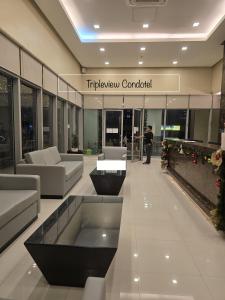 a lobby with a couch and a table in a building at 8 Adriatico Manila Condotel Sea View Corner Unit Near St Lukes Clinic in Manila +31 photos