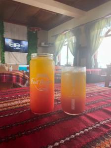 two glasses of drinks sitting on a table at Къща за гости Динас in Zmeitsa