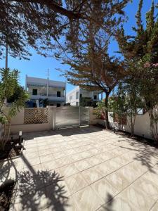 a patio in front of a house with trees at Casa GIOSA in Baia Verde