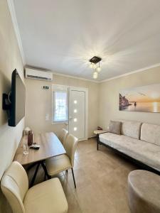 a living room with a couch and a table at Comfy Apartments Center in Nikiti