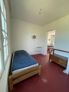 a bedroom with a bed and a bench in it at Maison sur la Mer - FrontSea in Angoulins-sur-Mer