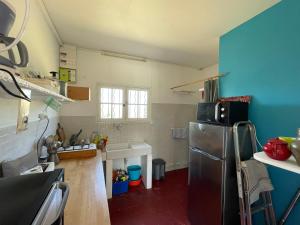 a kitchen with a stainless steel refrigerator and blue walls at Maison sur la Mer - FrontSea in Angoulins-sur-Mer +5 photos