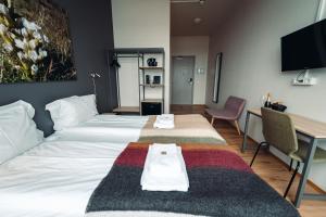 Postel nebo postele na pokoji v ubytování Geo Hotel