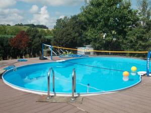 a large swimming pool on a wooden deck at Ferienwohnung Neubert in Eibenstock