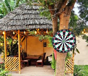 a dart board on a tree next to a hut at Safi House in Boma la Ngombe