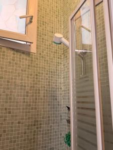 a shower with a glass door in a bathroom at Stylish City Stay ,1-Bedroom ,Eiffel Tower Nearby in Vincennes