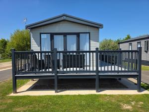 a bench in front of a tiny house at Grange Leisure Park, Mablethorpe in Mablethorpe