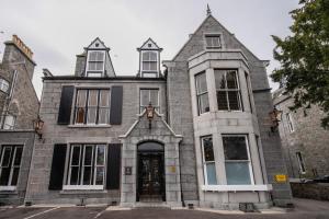 an old stone house with a front door at The Dutch Mill Hotel in Aberdeen +24 photos