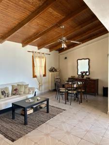 a living room with a couch and a table at Ziras Traditional Villa in Áno Váthia