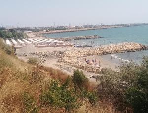 a beach with umbrellas and a group of people at Samaya in Agigea +7 photos