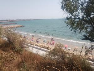 a group of people on a beach with the ocean at Samaya in Agigea