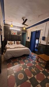 a bedroom with a large bed and a rug at Dylan Cafe And Guest House in Jodhpur
