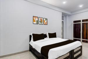 a bedroom with a black and white bed in it at Hotel Sanwariya in Jaipur