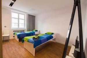 a room with two beds and a camera at HappyEstate Apartments 3 min do Rynku in Wrocław