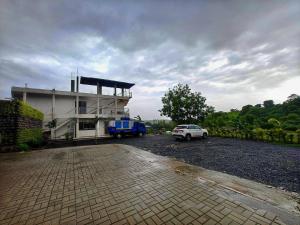 a building with a car parked in front of it at The Clouds Resort Arambol, Goa in Arambol