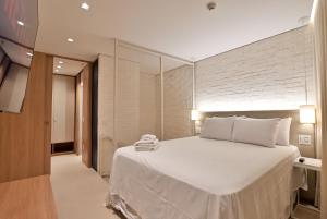 Voodi või voodid majutusasutuse Cobertura Duplex Luxuosa no Hotel Fusion toas