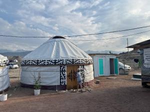 a large yurt in the middle of a desert at Crocodile Tash in Tong +19 photos